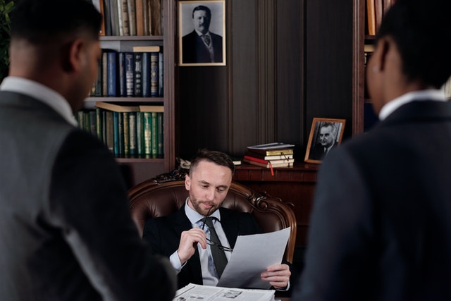 legal experts looking over documents with two associates standing in front of them